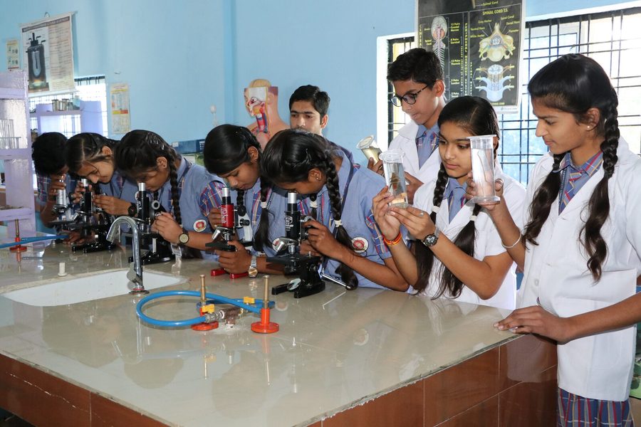 Students using microscopes in the biology laboratory